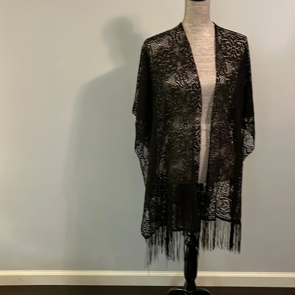 Unknown maker size one size fits all. Black shawl no arm holes.